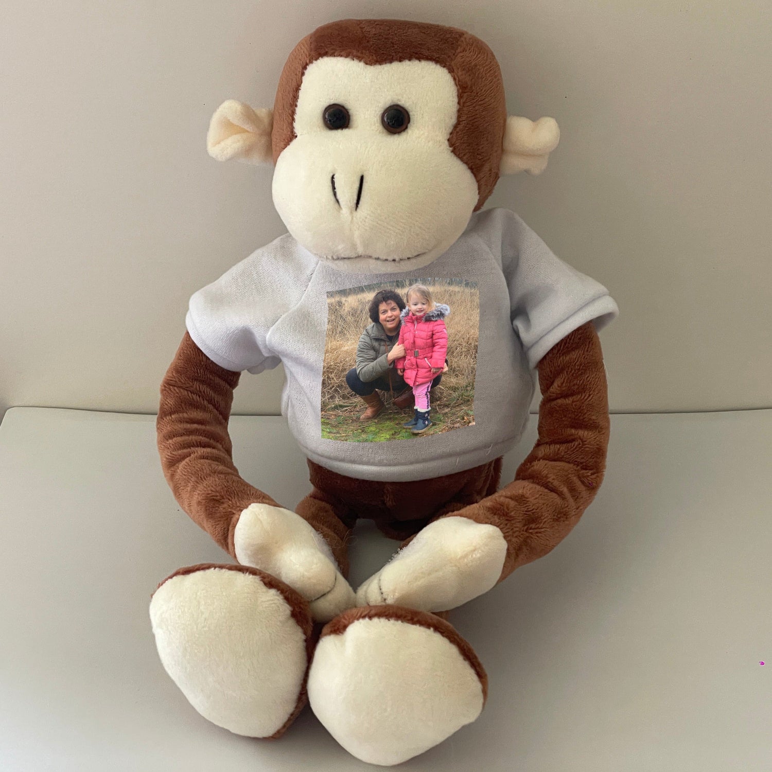 Knuffel aapje met bedrukt shirt